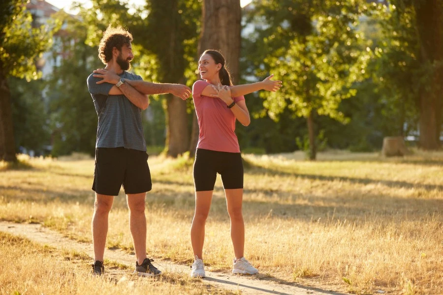 Man and women outside doing physical activity.